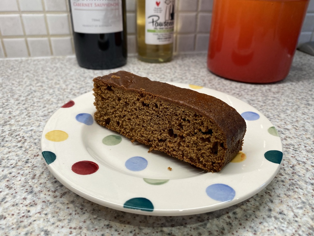 Photograph of a slice of ginger cake on a polka dot plate